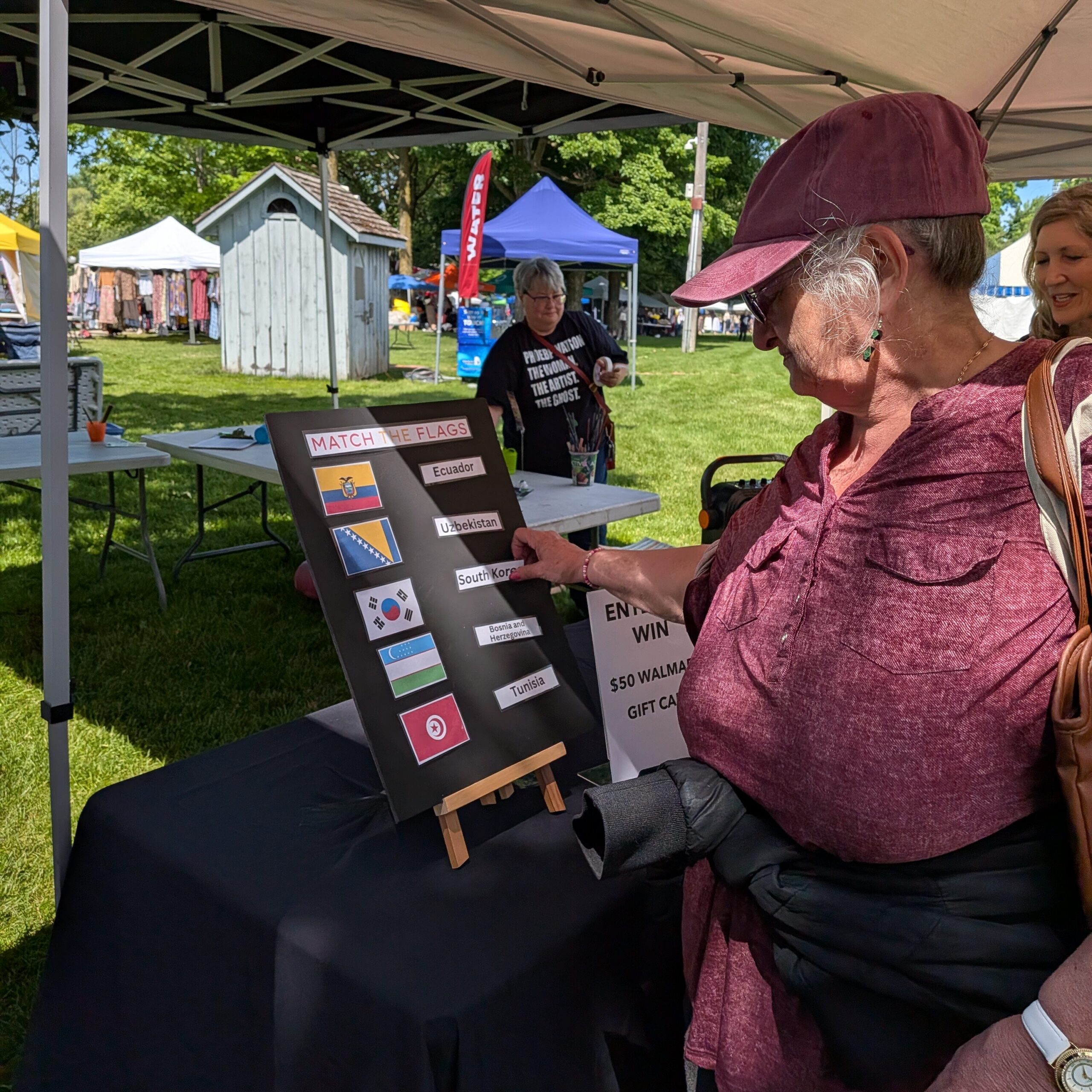 MFE Booth at KWMC Festival - woman playing Match the Flag