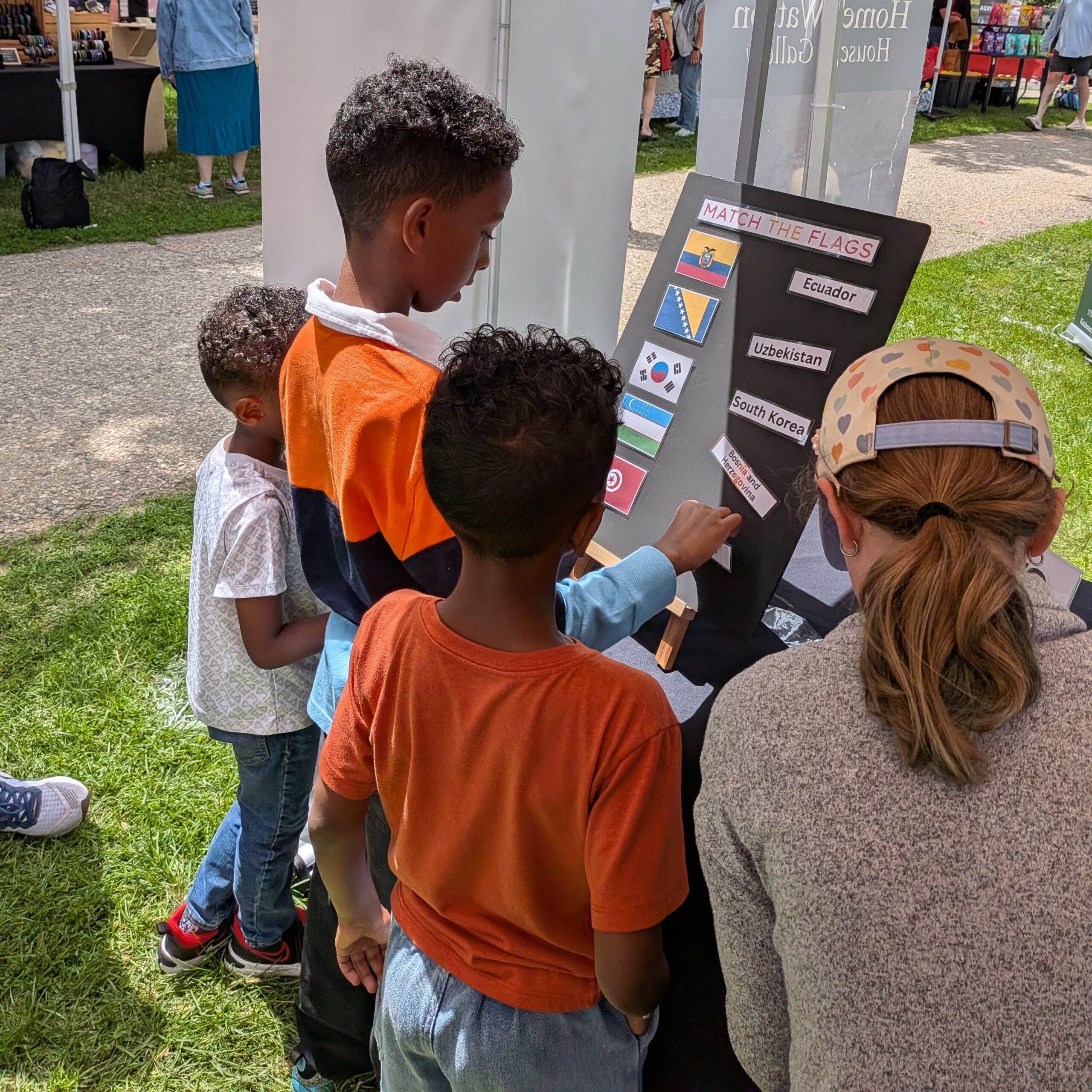 MFE Booth at KWMC Festival - youth playing Match the Flag