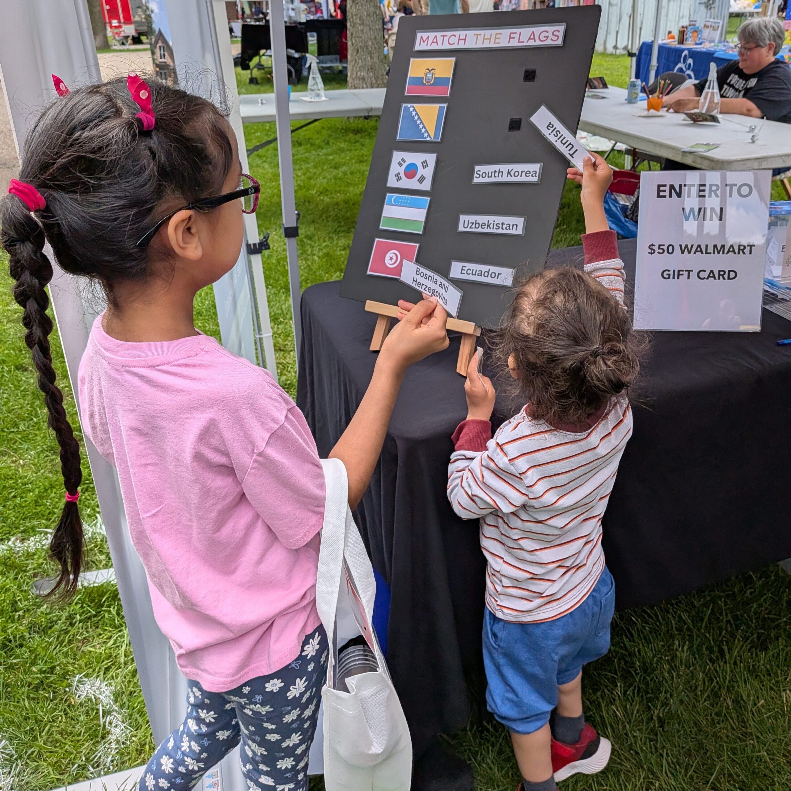 MFE Booth at KWMC Festival - activity participants playing Match the Flag
